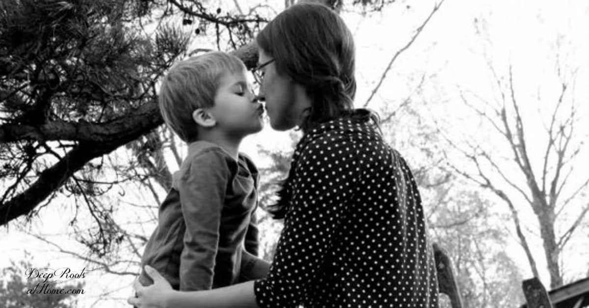 Help Your Son To Find His Wings & Do Great Things. A mother and son hugging and about to kiss.