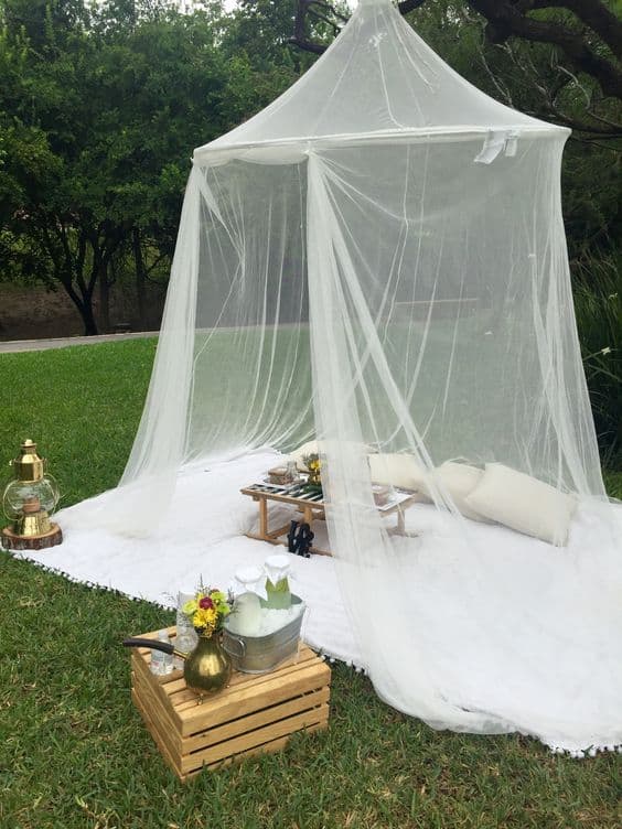 mosquito netting over an outdoor conversation area