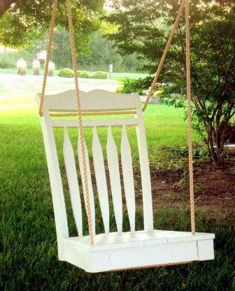 A white backyard chair swing