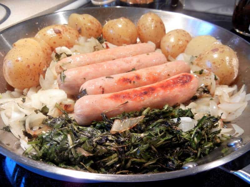 Cooking greens with sausage, onions and greens
