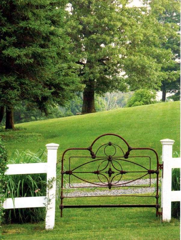 Creating Whimsy In Your Backyard & Garden, Part Two. An old metal headboard,of a bed used as garden gate