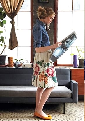 A woman reading newspaper in a cute mix 'n match outfit