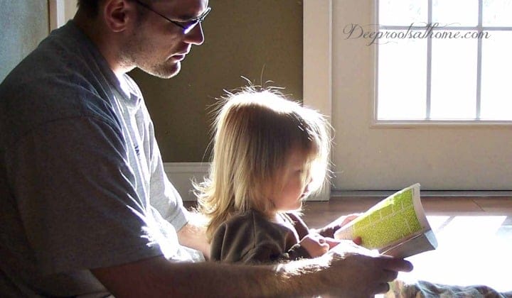 The Father/Daughter Relationship & What a Mom Can Do to Facilitate It. A father reading the Bible to his daughter