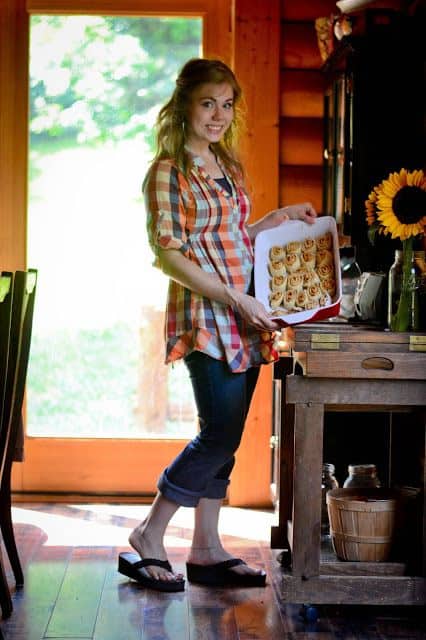 A gal in a buffalo check tunic top over jeans