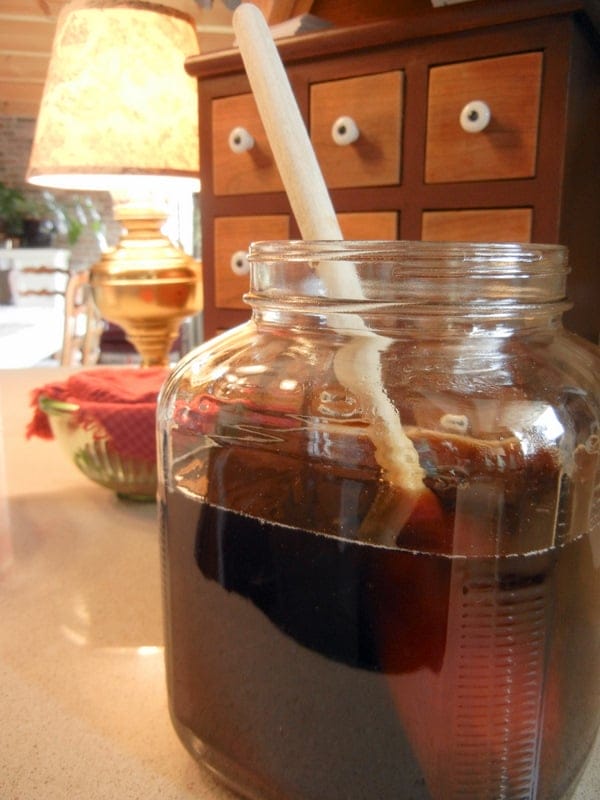 A Complete Beginner's Guide To Brewing Your Own Kombucha. Melting the sugar to make a sweet tea before adding the scoby