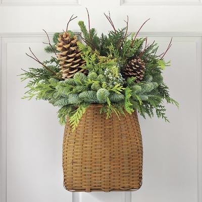 Simply Classic & Timeless Natural Holiday Decorations. pine boughs in a wicker basket for door