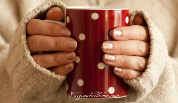The Many Health Benefits Of Red Rooibos Tea. Beautiful hands holding a warm mug of Rooibos tea with anti-viral, anti-mutagenic, anti-allergic, anti-carcinogenic, anti-inflammatory powers.