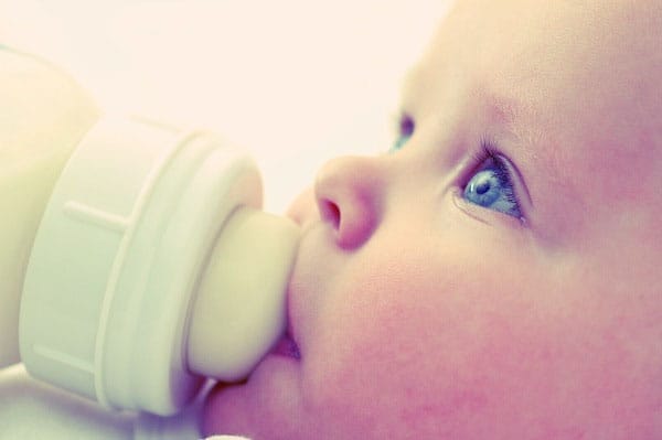 Addictive Flavors & How the Food Giants Have Us Hooked. Baby drinking infant soy formula,