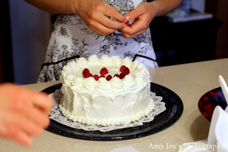 White Chocolate Raspberry Torte Recipe & Tutorial. Adding raspberries to dress the torte 