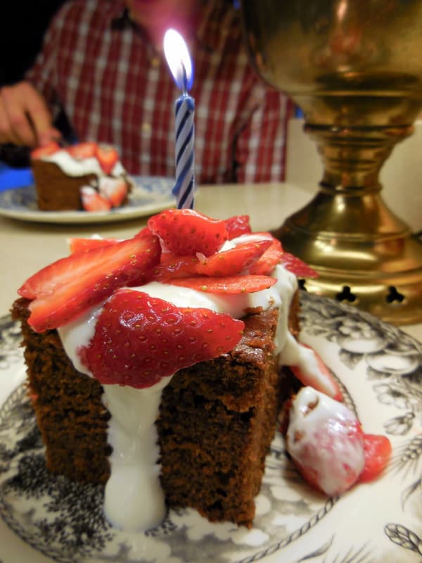 Chocolate Birthday cake with icing and fresh strawberries 