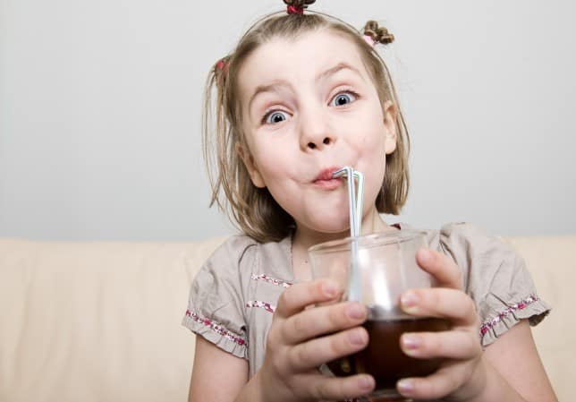 How Could A Diet Soda A Day Be A Problem? Here Are 8 Ways. A 10 year old drinking a carbonated soda with a straw.