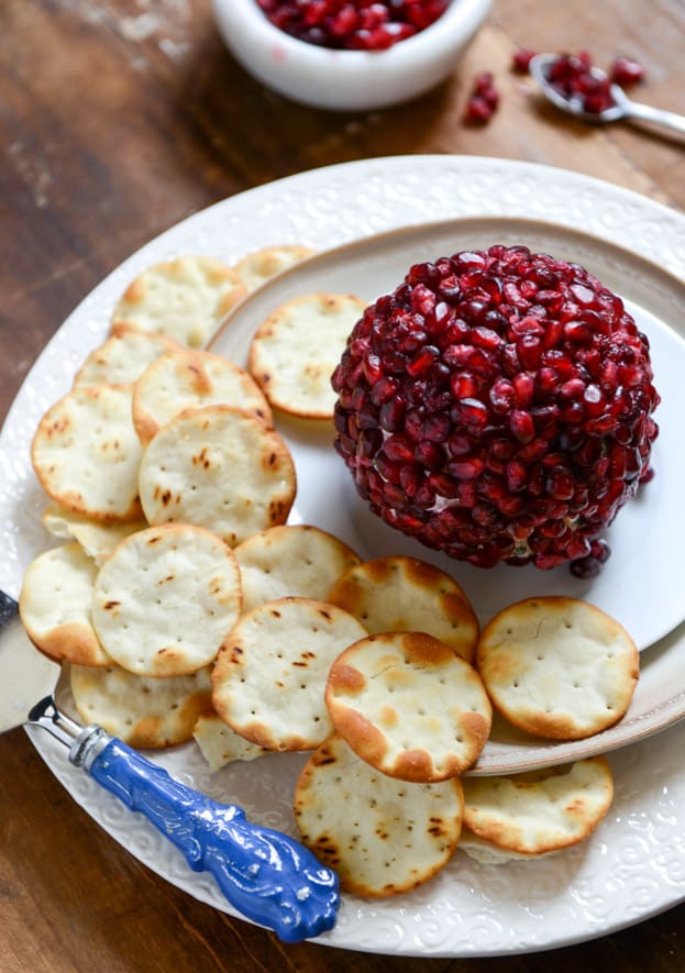 29 Festive Pomegranate Recipes & De-Seeding Video. Pomegranate-Jeweled White Cheddar, Toasted Almond, and Crispy Sage Cheese Ball  {How Sweet It Is}