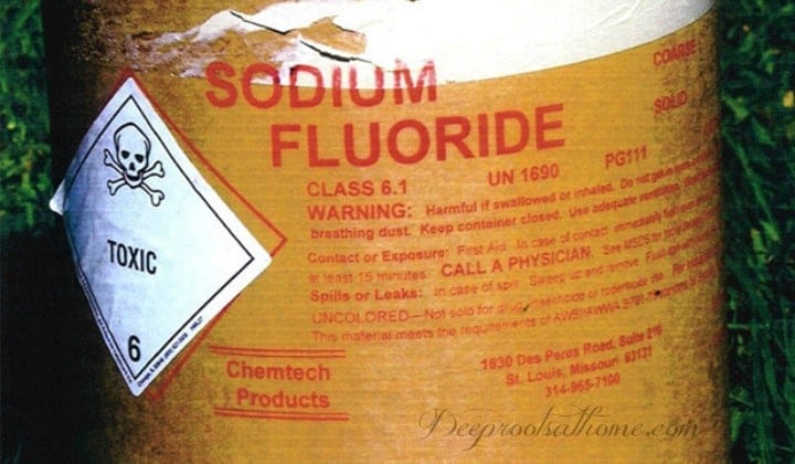 Fluoride: Not About Kid’s Teeth, About Ditching Hazardous Waste for Profit. Image of a barrel of fluoride, a toxic waste byproduct of aluminum