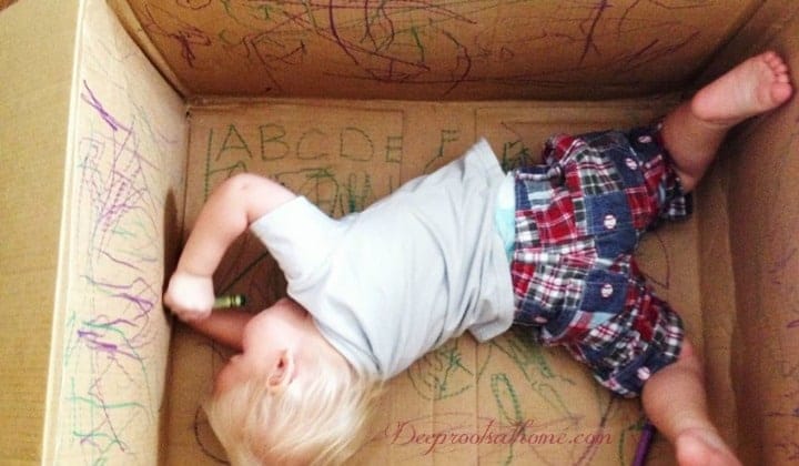 Does Your Child Have Time to Play? Just...Play? A happy and entertained child playing alone with markers in a cardboard box.