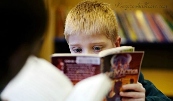 Books Unhealthy For Children {Recent Newbery, Caldecott & YA}, a young boy obviously shocked by what he is reading!