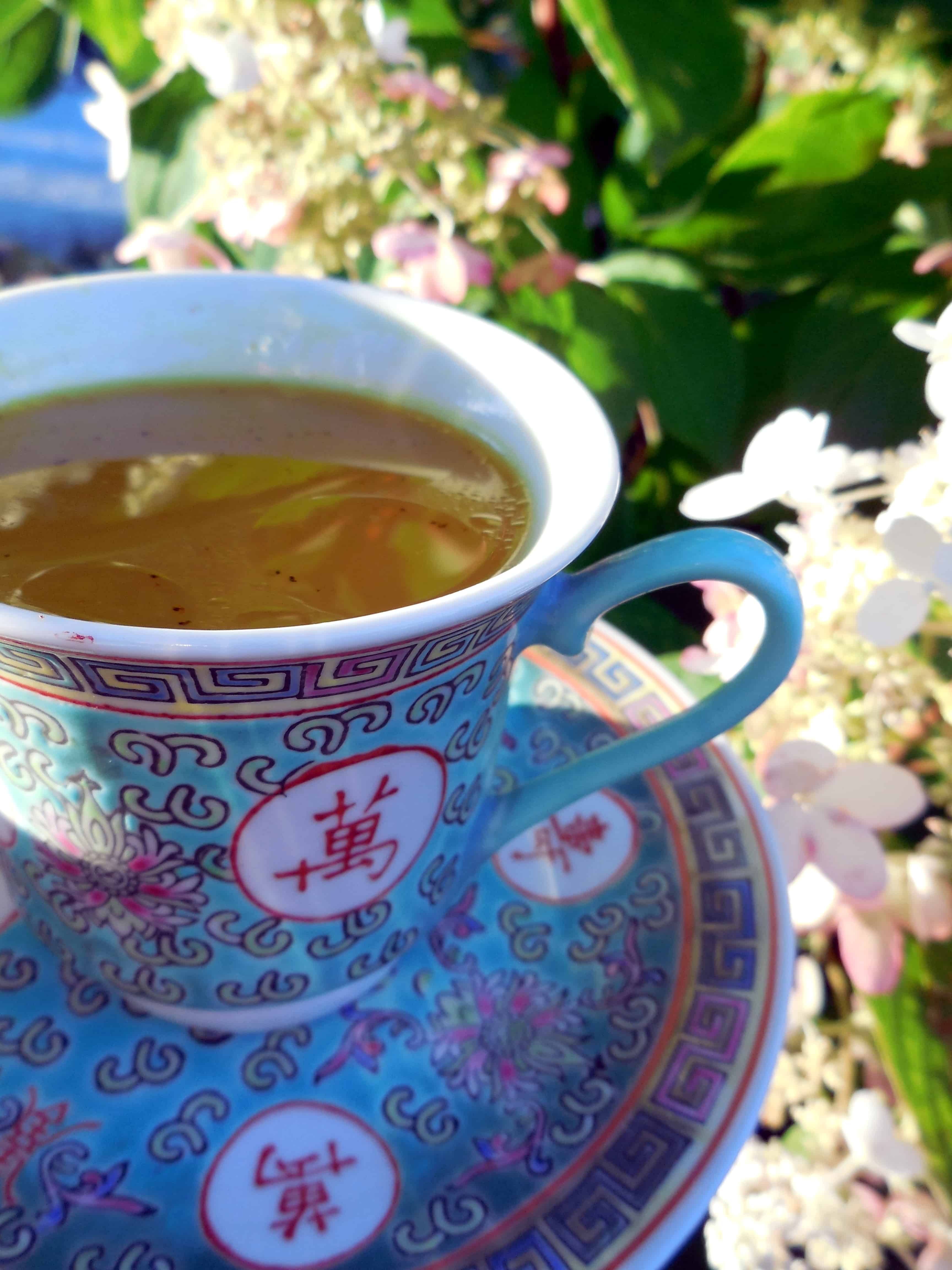Hot turmeric tea in a Chinese tea cup