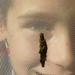 boy looking at a caterpillar