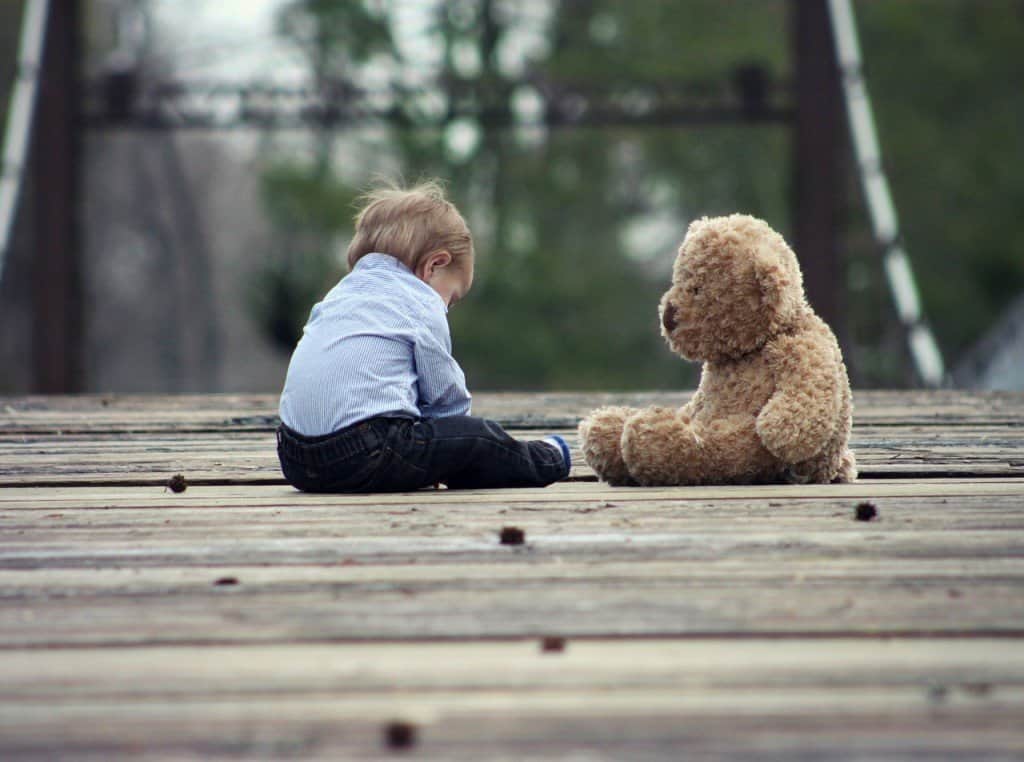 Boys Think and Process Differently Than Girls. Boys Think, See, Hear & Process Very Differently Than Girls. A cute boy and teddy bear sitting on the bridge