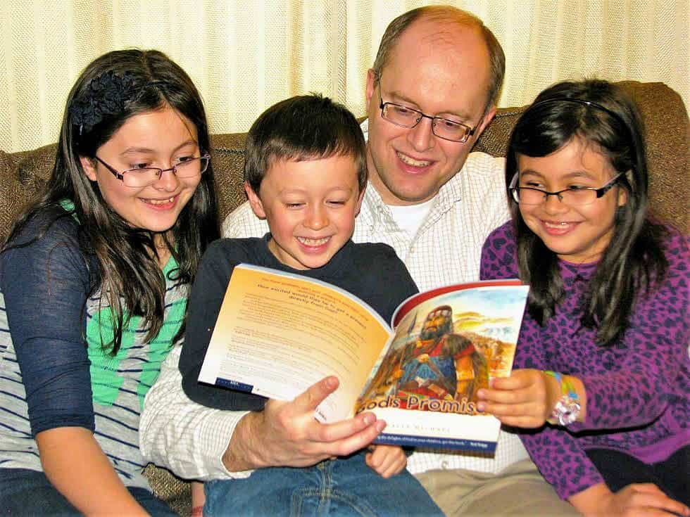 Teach The Whole Counsel of God: Don't Just Teach Bible Stories. parent reading 'God's Promises' to children