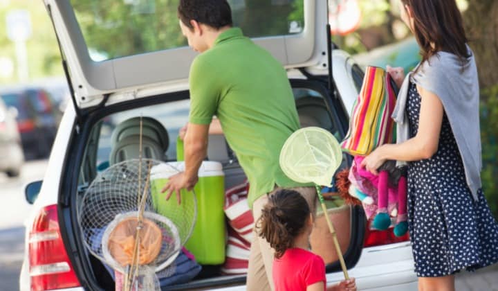 Road-Tripping This Summer? Winning Audiobooks For Families Road-Tripping This Summer? Winning Audiobooks For Families, a family packing the car for a long trip