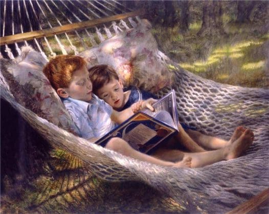 2 boys in a hammock reading
