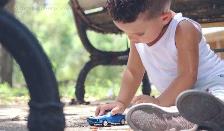 4 Crucial Brain Differences Between Boys & Girls: Why We Act & Think So Differently. A young boy playing with a blue Hot Wheels car.