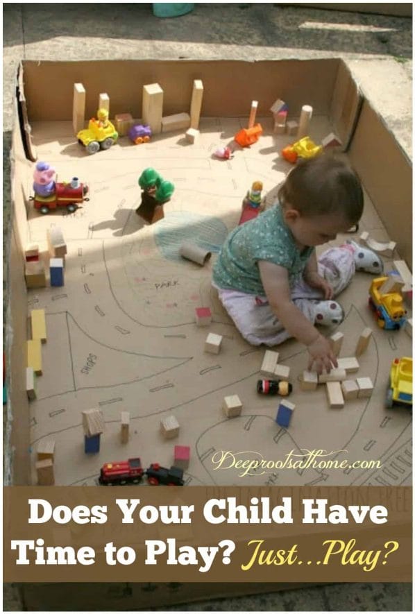 Does Your Child Have Time to Play? Just...Play? A happy and engrossed toddler playing in a big cardboard box with blocks. 
