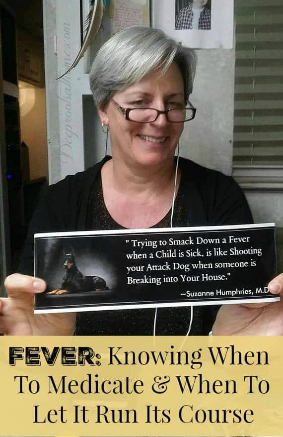 Knocking Down A Fever Is Like Shooting Your Attack Dog In a Burglary. A smiling Dr. Suzanne Humphries holds her "Smack down a fever" quote made into a bumper sticker.