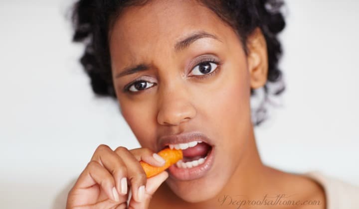 True Vitamin A Food Sources & Why You Can't Get Enough from Carrots. A young African-American woman bites down on a carrot stick.
