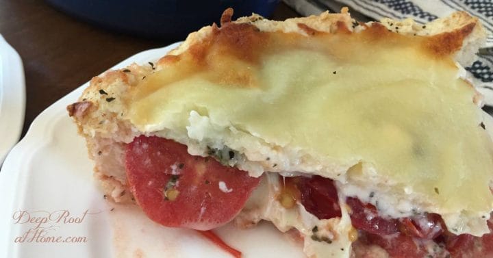 Olivia's Tomato Pie: Savory, Cheesy Summertime Favorite. A freshly cut slice of delectable summer tomato pie!