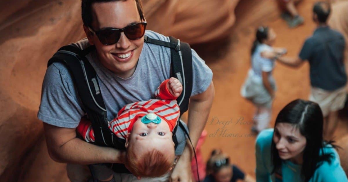 Outward-Facing Baby Carriers Harm Baby's Developing Hips & More Outward-Facing Baby Carriers Harm Baby's Developing Hips & More. Dad carrying baby in inward facing position