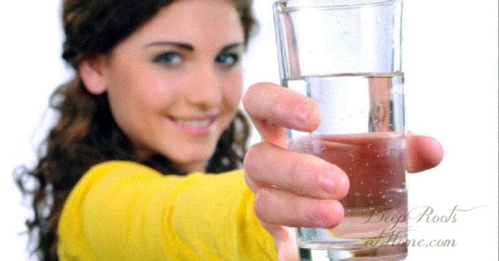holding out glass of water for acid reflux